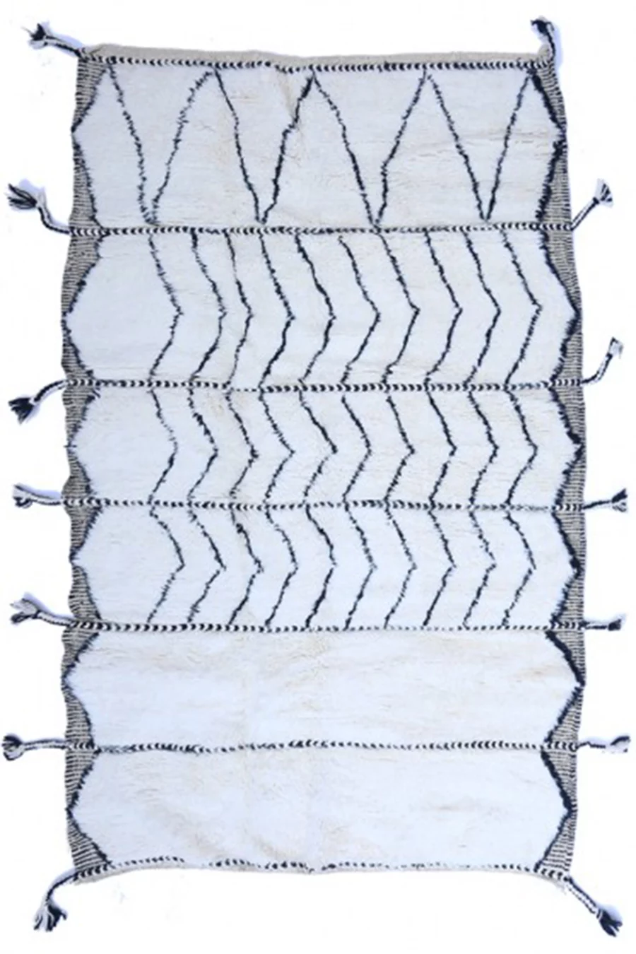 Multi-panel tribal Beni Ourain wool rug with tassel details.